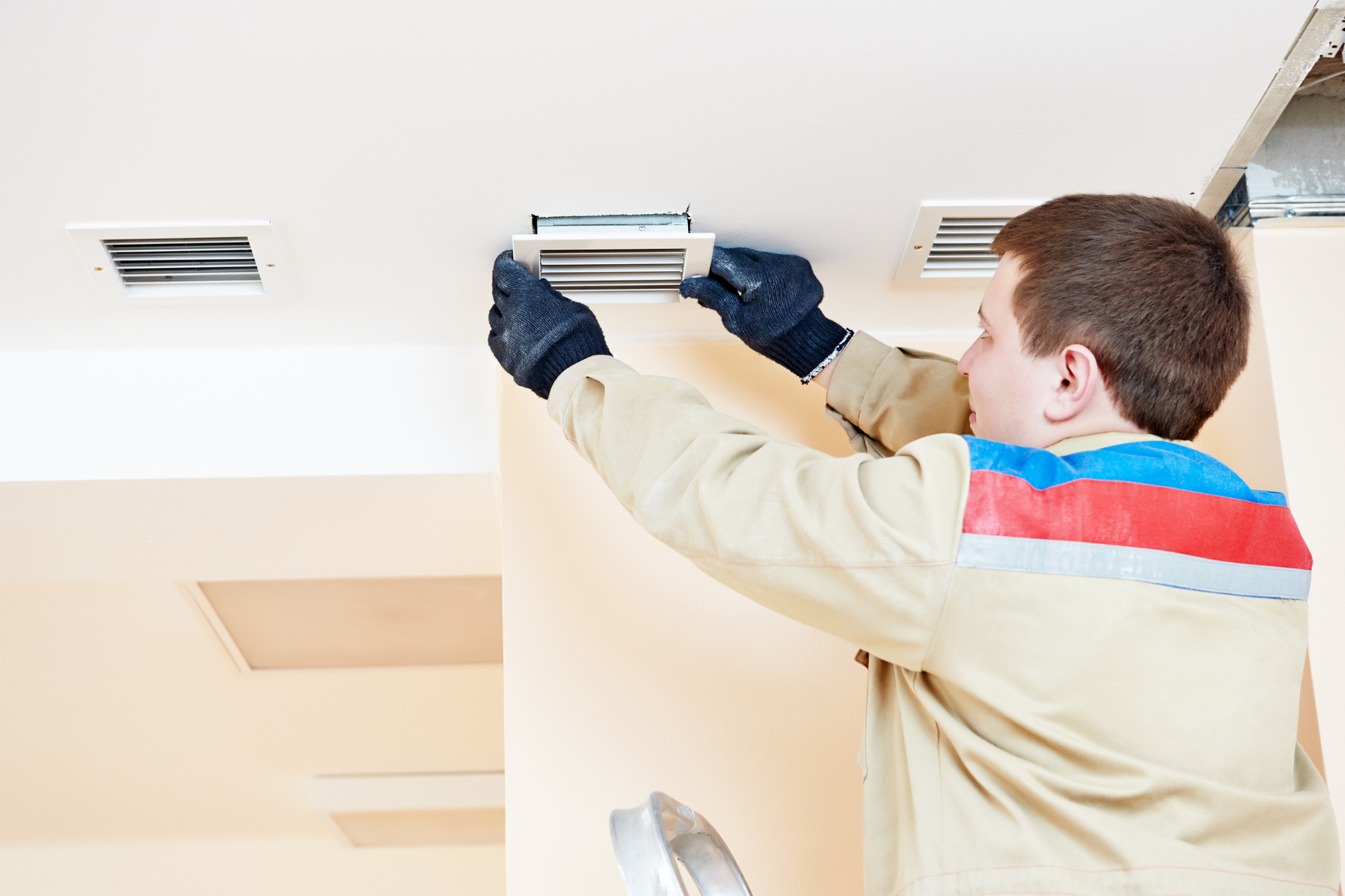 Man installing vents to climate control your home | From Draughts To Digits: Combining Traditional And Tech Methods To Climate Control Your Home | Aqara